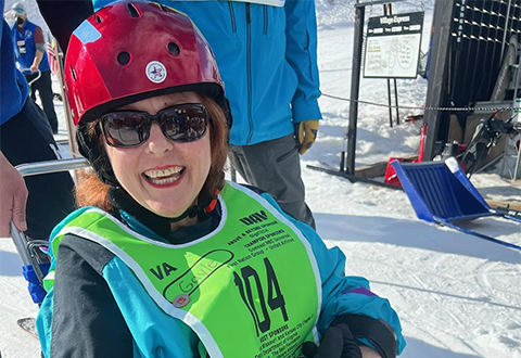 Gayle-Jayne Allyson grins from beneath her helmet after a bi-ski run